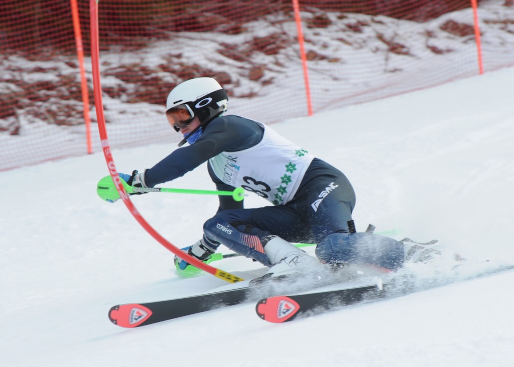 Skier carving fresh corduroy runs at sunrise